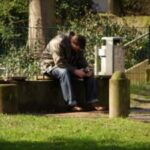 man in dispair on bench