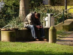man sitting on bench in dispair